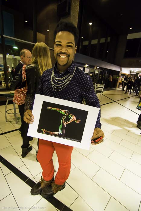 After the show Saturday night - Kameron Saunders holding a picture from Wednesday's dress of his performance in 'A Hint of Mischief' by DeeAnna Hiett in a lift with Simone DeLozier